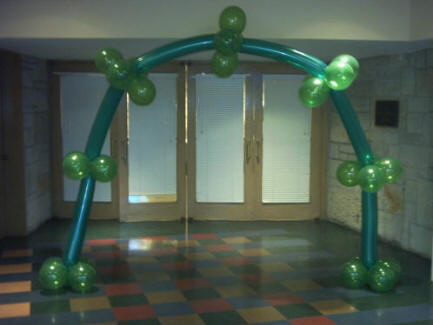 Large arch consisting of huge six inch diameter balloons that are creatively contected with four round balloons of a matching color at each joint.