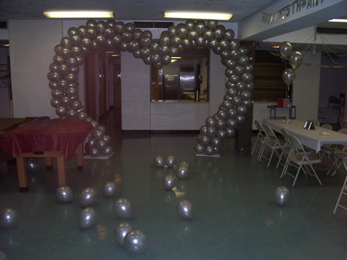 Silver Heart Arch and Scattered Balloons